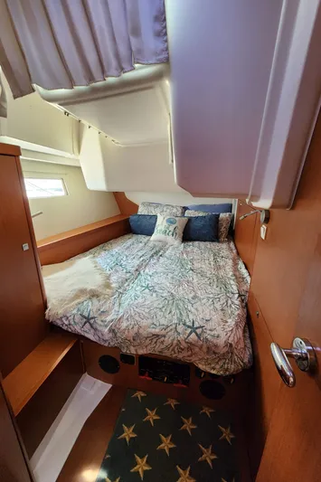 Day One Yacht Photos Pics Cozy cabin interior of 2016 Beneteau Oceanis 45 sailboat with nautical bedding.