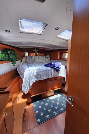 Day One Yacht Photos Pics Cozy cabin interior of 2016 Beneteau Oceanis 45 sailboat with skylights and nautical decor.