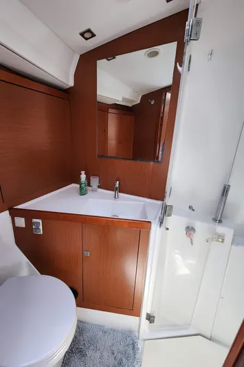 Day One Yacht Photos Pics 2016 Beneteau Oceanis 45 bathroom with wood cabinetry and modern fixtures.