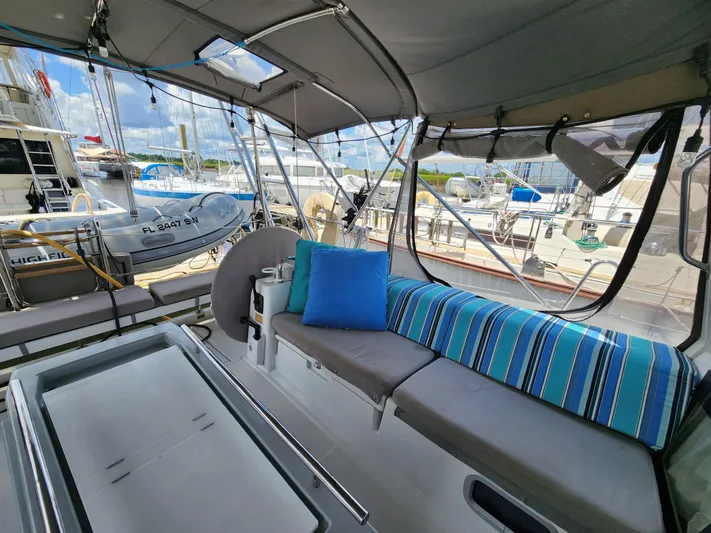 Day One Yacht Photos Pics Interior view of 2016 Beneteau Oceanis 45 sailboat with comfortable seating and colorful cushions.