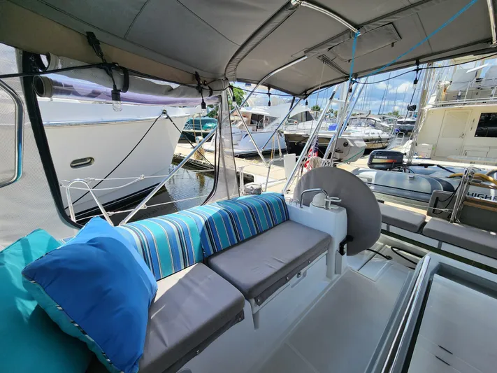 Day One Yacht Photos Pics 2016 Beneteau Oceanis 45 sailboat interior with striped cushions at marina.