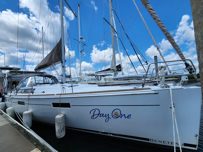 Day One Yacht Photos Pics 2016 Beneteau Oceanis 45 sailboat docked under blue sky.