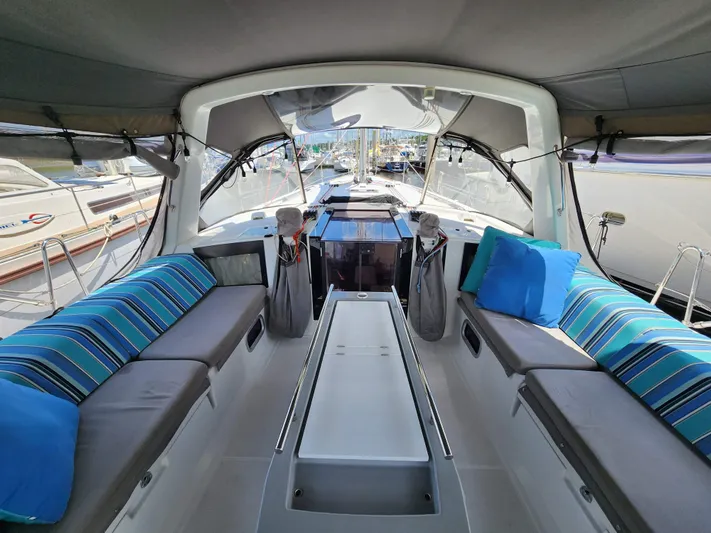 Day One Yacht Photos Pics 2016 Beneteau Oceanis 45 yacht interior with striped cushions and spacious seating area.