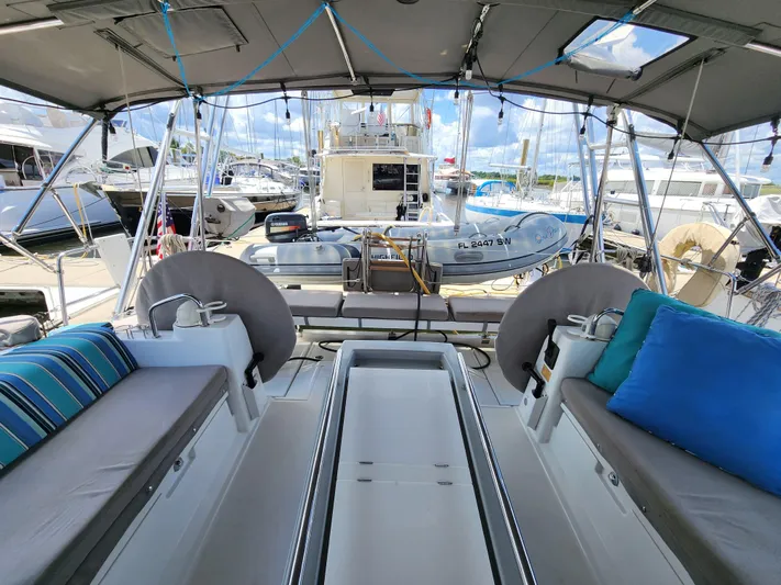 Day One Yacht Photos Pics Spacious cockpit of 2016 Beneteau Oceanis 45 yacht with comfortable seating and marina view.