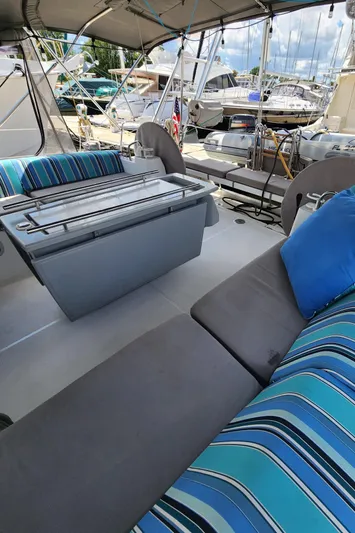 Day One Yacht Photos Pics 2016 Beneteau Oceanis 45 yacht interior with striped cushions and seating area.