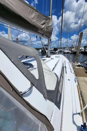 Day One Yacht Photos Pics 2016 Beneteau Oceanis 45 sailboat docked under a bright blue sky.