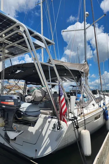 Day One Yacht Photos Pics 2016 Beneteau Oceanis 45 sailboat docked, featuring solar panels and an American flag.