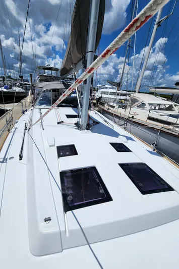 Day One Yacht Photos Pics 2016 Beneteau Oceanis 45 sailboat deck with clear sky and marina background.