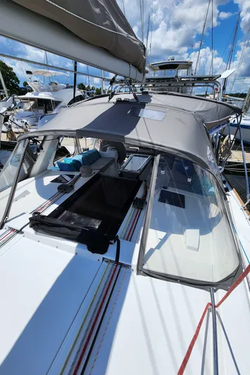 Day One Yacht Photos Pics 2016 Beneteau Oceanis 45 sailboat docked under a sunny sky.