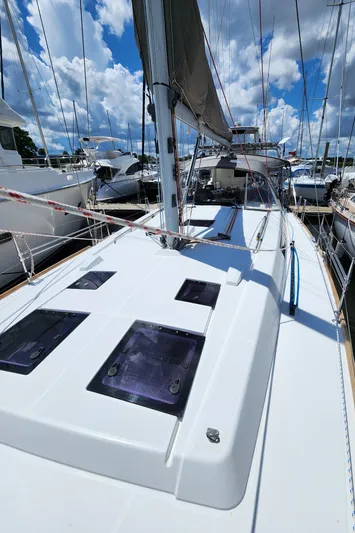 Day One Yacht Photos Pics 2016 Beneteau Oceanis 45 sailboat docked under a blue sky.