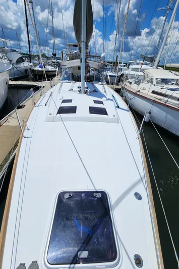 Day One Yacht Photos Pics 2016 Beneteau Oceanis 45 sailboat docked at marina under blue sky.