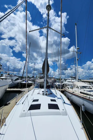 Day One Yacht Photos Pics 2016 Beneteau Oceanis 45 sailboat docked under a vibrant blue sky.