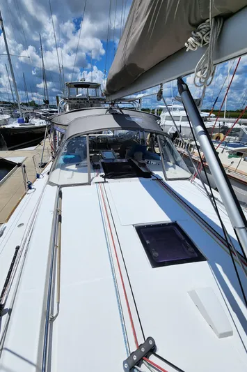 Day One Yacht Photos Pics 2016 Beneteau Oceanis 45 sailboat docked under a partly cloudy sky.
