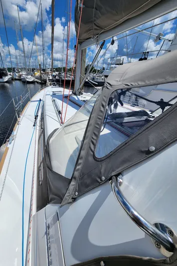 Day One Yacht Photos Pics 2016 Beneteau Oceanis 45 sailboat deck with clear skies and marina view.