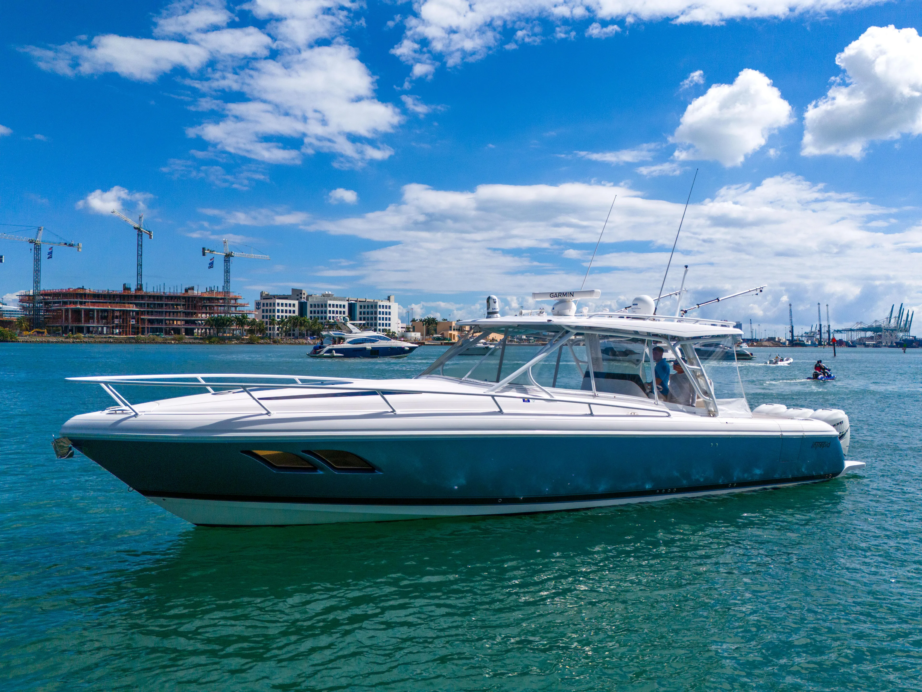  Yacht Photos Pics 2019 Intrepid 407 Cuddy boat on clear blue water under a sunny sky.