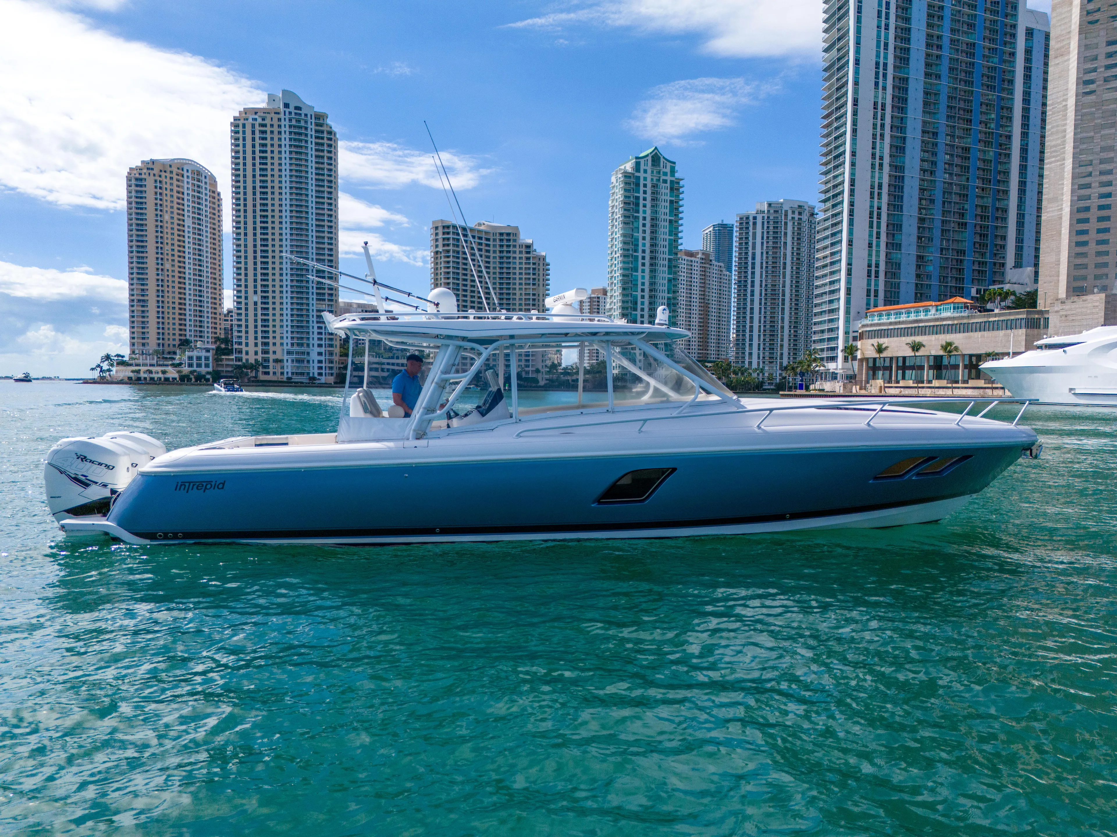  Yacht Photos Pics 2019 Intrepid 407 Cuddy boat cruising near city skyline.