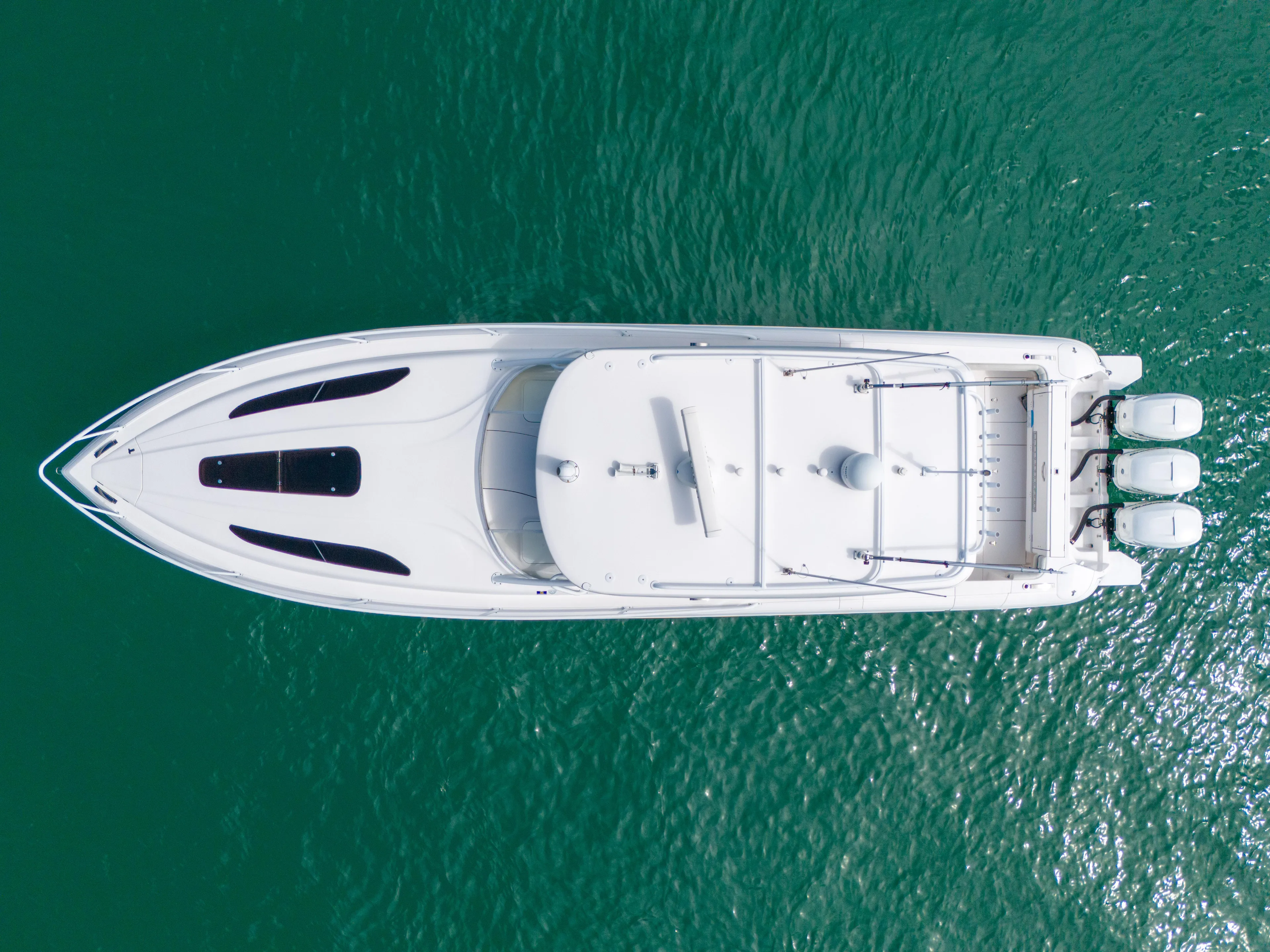  Yacht Photos Pics Aerial view of 2019 Intrepid 407 Cuddy boat on turquoise water.