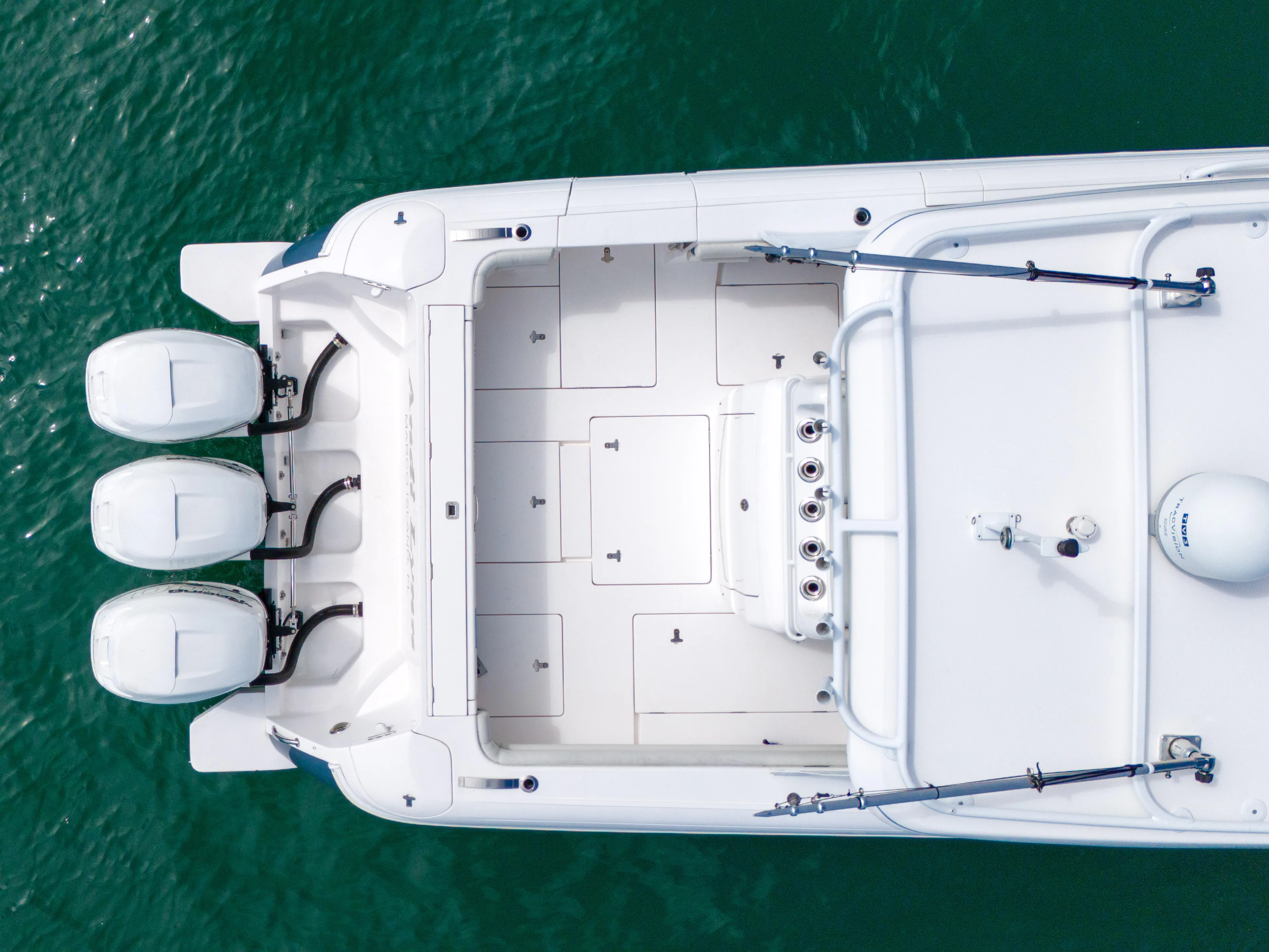  Yacht Photos Pics Aerial view of 2019 Intrepid 407 Cuddy boat with triple engines on turquoise water.