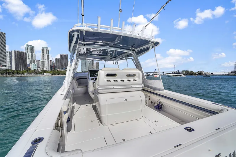  Yacht Photos Pics 2019 Intrepid 407 Cuddy boat on water with city skyline in background.