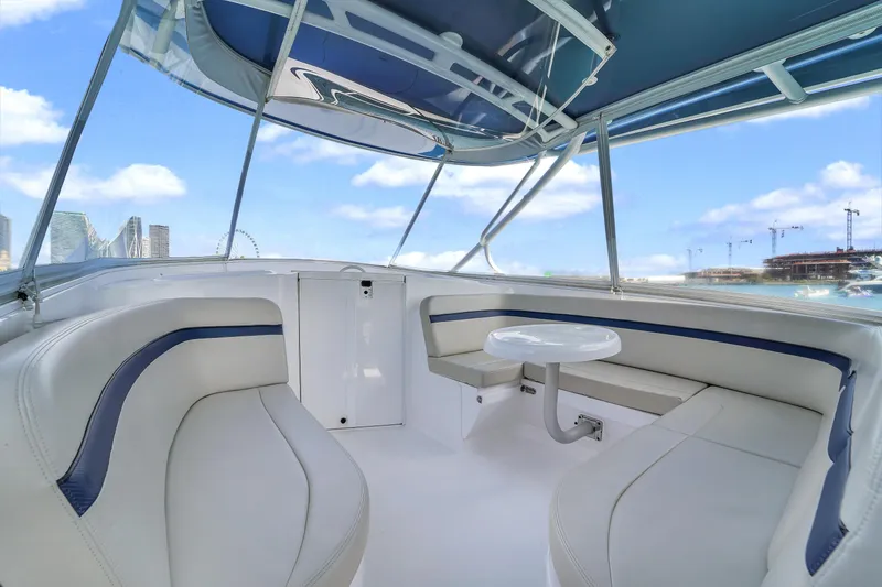  Yacht Photos Pics 2019 Intrepid 407 Cuddy interior with seating and table, under blue sky.