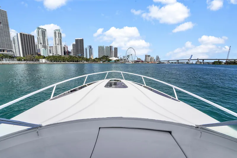  Yacht Photos Pics 2019 Intrepid 407 Cuddy cruising towards city skyline and Ferris wheel on a sunny day.