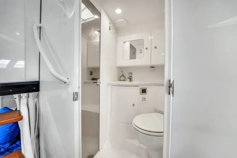  Yacht Photos Pics 2019 Intrepid 407 Cuddy boat bathroom with modern white interior design.