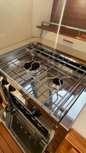  Yacht Photos Pics 2023 Ranger Tugs R-27 boat kitchen with stainless steel stove and oven.