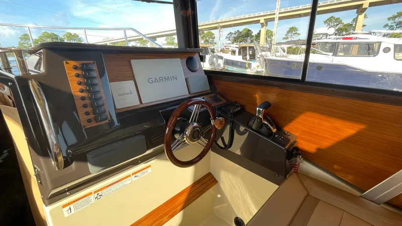  Yacht Photos Pics 2023 Ranger Tugs R-27 helm with Garmin navigation system and wooden steering wheel.