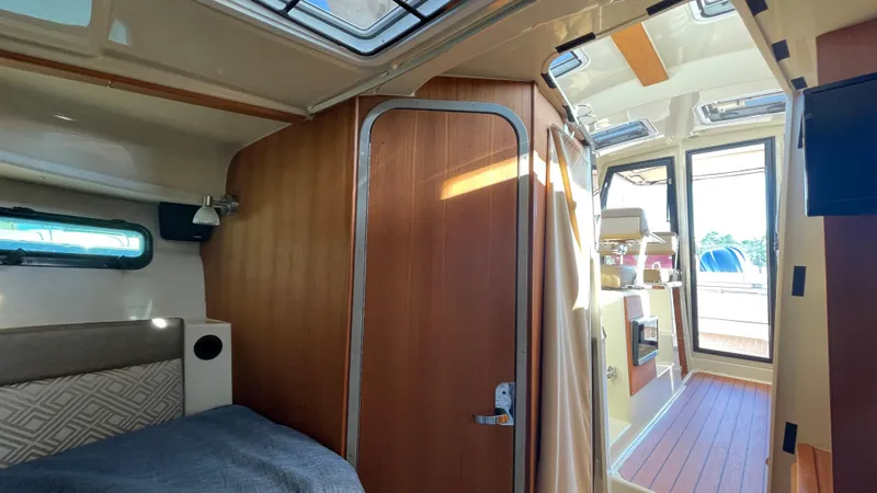  Yacht Photos Pics 2023 Ranger Tugs R-27 interior cabin with wood finishes and natural light.