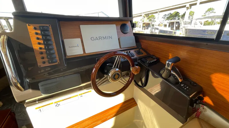  Yacht Photos Pics 2023 Ranger Tugs R-27 helm with Garmin navigation system and wooden steering wheel.