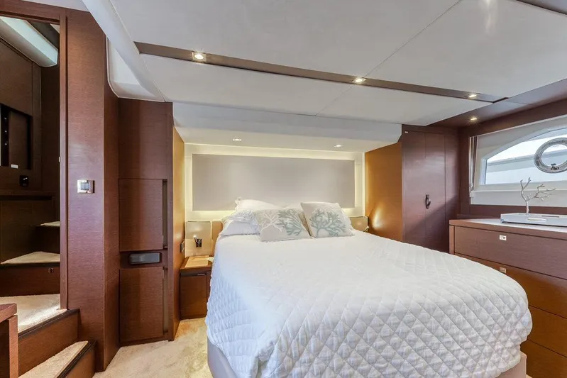 Knightlife Yacht Photos Pics Luxurious bedroom interior of a 2017 Prestige 630 yacht with elegant wood finishes.