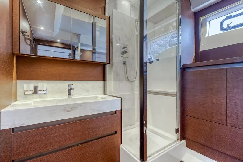 Knightlife Yacht Photos Pics Luxurious bathroom in 2017 Prestige 630 yacht with modern fixtures and wooden cabinetry.