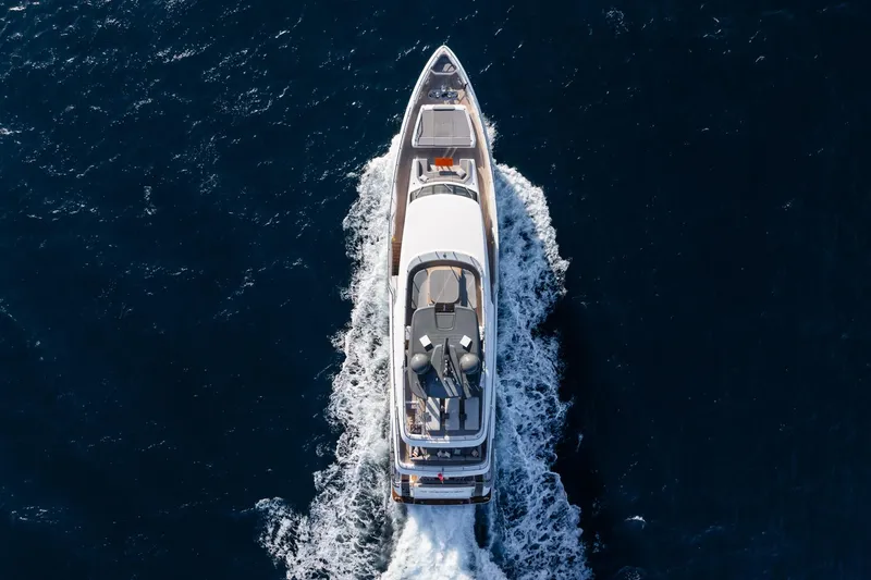 M Forever Yacht Photos Pics Aerial view of 2021 Custom Line Navetta 33 yacht cruising on open sea.