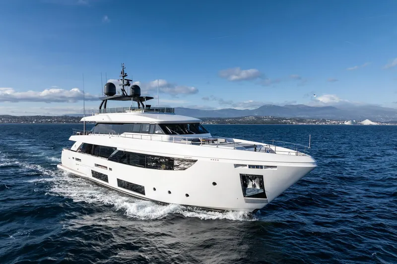 M Forever Yacht Photos Pics Luxurious 2021 Custom Line Navetta 33 yacht cruising on open sea under clear blue sky.
