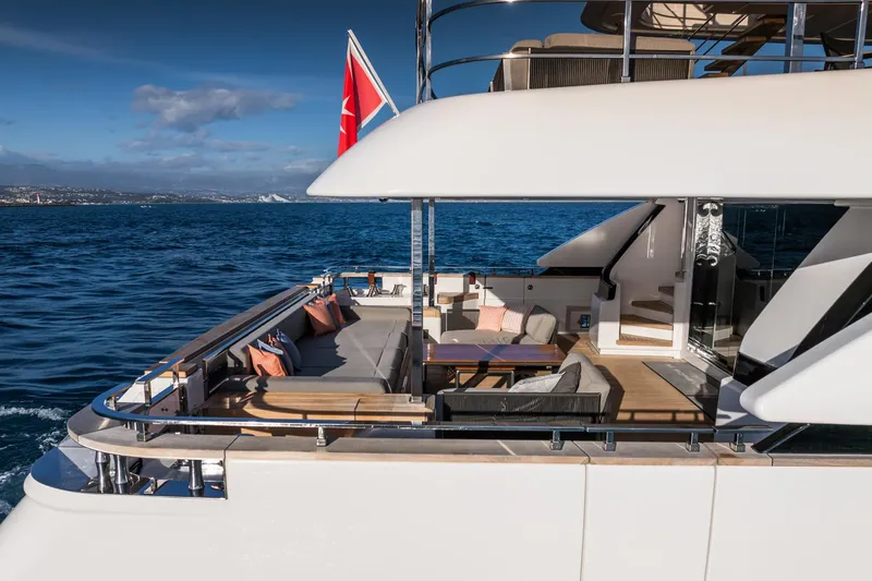 M Forever Yacht Photos Pics Luxurious 2021 Custom Line Navetta 33 yacht with elegant outdoor seating on open sea.