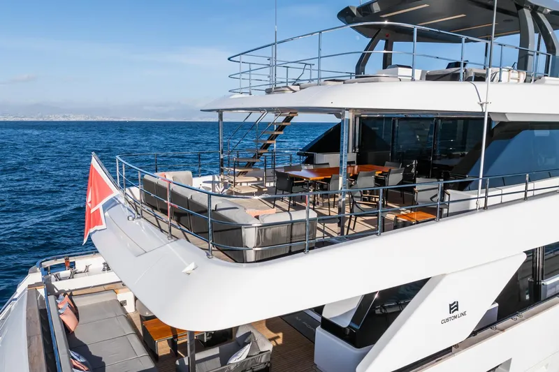 M Forever Yacht Photos Pics Luxurious 2021 Custom Line Navetta 33 yacht with spacious deck and elegant seating, cruising on open sea.