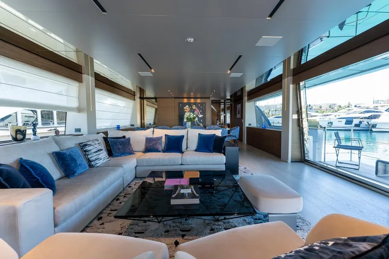 M Forever Yacht Photos Pics Luxurious interior of 2021 Custom Line Navetta 33 yacht with elegant seating and large windows.