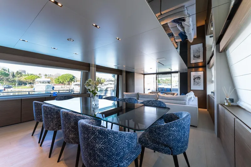 M Forever Yacht Photos Pics Luxurious interior of 2021 Custom Line Navetta 33 yacht with elegant dining area and scenic views.