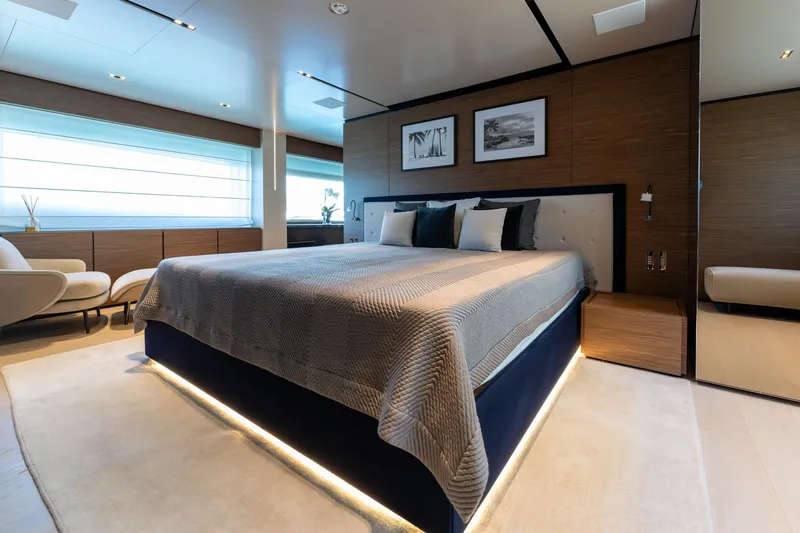 M Forever Yacht Photos Pics Luxurious bedroom interior on Custom Line Navetta 33 yacht, 2021 model, featuring elegant decor and ambient lighting.
