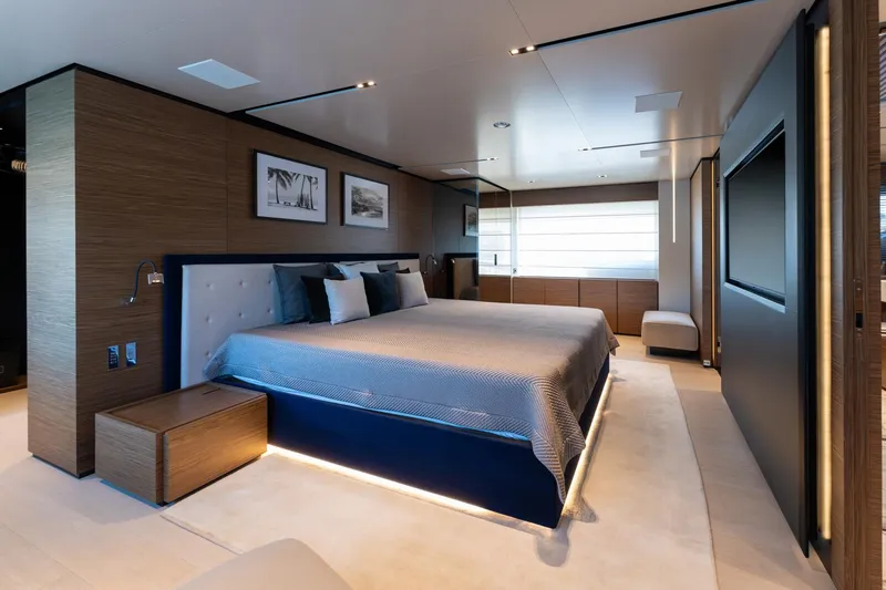 M Forever Yacht Photos Pics Luxurious bedroom interior on 2021 Custom Line Navetta 33 yacht, featuring modern design and elegant furnishings.