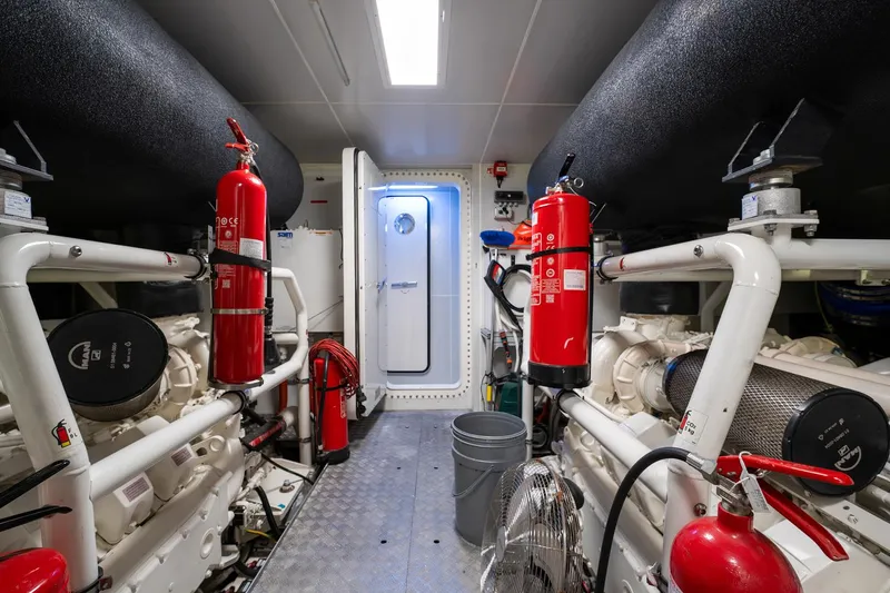 M Forever Yacht Photos Pics Engine room of 2021 Custom Line Navetta 33 yacht with fire extinguishers and machinery.