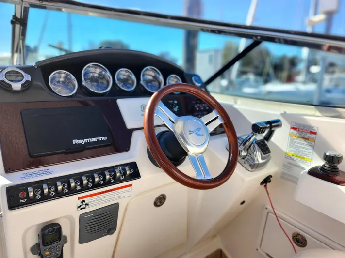 St Babyn Yacht Photos Pics 2012 Sea Ray Sundancer 310 helm with Raymarine electronics and wood-accented steering wheel.