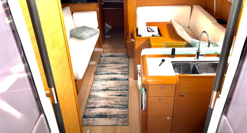  Yacht Photos Pics Interior of 2018 Jeanneau Sun Odyssey 419 yacht with modern kitchen and seating area.