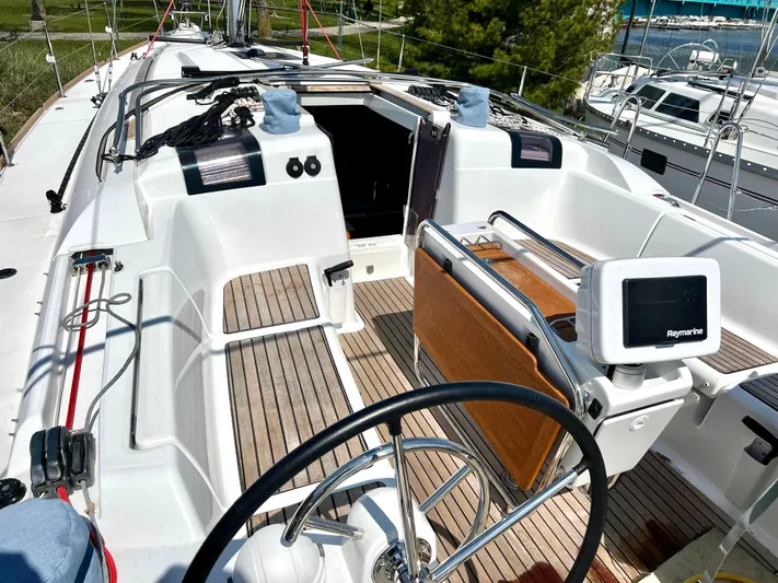  Yacht Photos Pics 2018 Jeanneau Sun Odyssey 419 sailboat cockpit with steering wheel and navigation equipment.