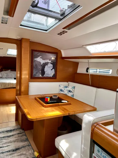  Yacht Photos Pics Interior of 2018 Jeanneau Sun Odyssey 419 sailboat with dining area and skylight.