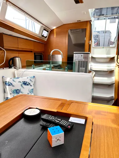  Yacht Photos Pics Interior of 2018 Jeanneau Sun Odyssey 419 yacht, featuring modern kitchen and cozy seating area.