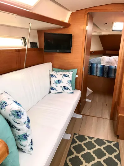  Yacht Photos Pics Interior of 2018 Jeanneau Sun Odyssey 419 yacht with cozy seating and nautical decor.