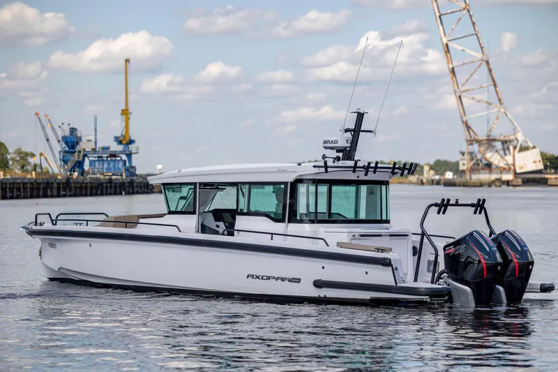  Yacht Photos Pics 2024 Axopar 37 XC boat on water with dual engines, industrial background.