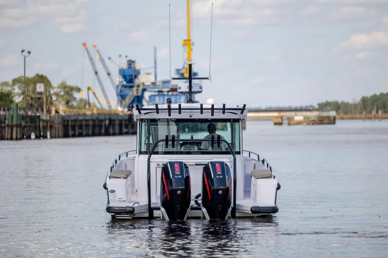  Yacht Photos Pics 2024 Axopar 37 XC boat with dual engines on a calm waterway.