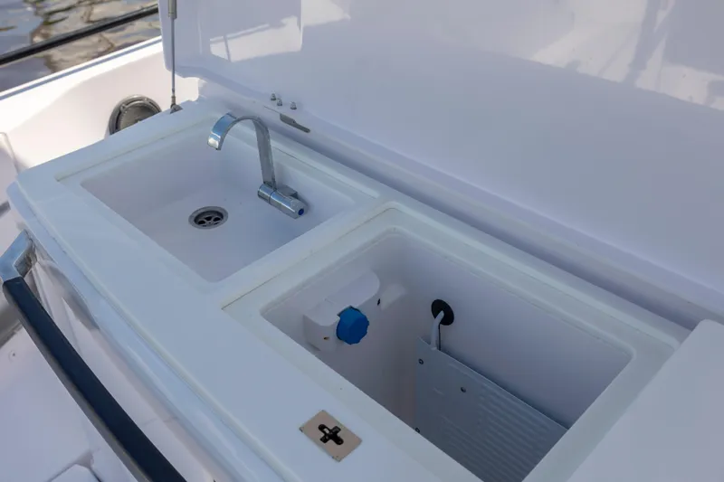  Yacht Photos Pics 2024 Axopar 37 XC boat sink and storage compartment detail.